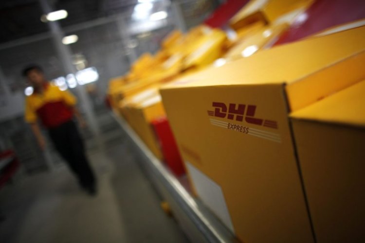 An employee is seen next to his workstation during a operational test of the new DHL North Asia Hub in Shanghai July 12, 2012. REUTERS/Carlos Barria (CHINA - Tags: BUSINESS TRANSPORT) - RTR34UOS