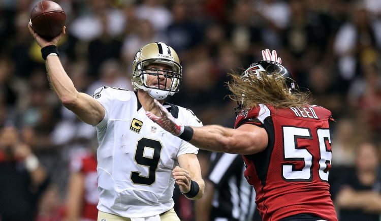 NEW ORLEANS, LA - OCTOBER 15:  Drew Brees #9 of the New Orleans Saints is pursued by Brooks Reed #56 of the Atlanta Falcons during the third quarter of a game at the Mercedes-Benz Superdome on October 15, 2015 in New Orleans, Louisiana.  (Photo by Sean Gardner/Getty Images)