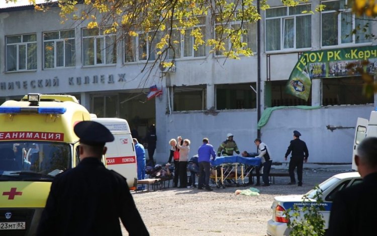 5669403 17.10.2018 In this video grab medical workers treat injured people outside a college building in Kerch, Crimea, Russia, October 17, 2018. Earlier in the day an unidentified explosive device filled with metal objects was detonated in the canteen of the college. A deadly blast that rocked the college in Crimea's Kerch is classified by investigators as a terrorist attack, the Russian Investigative Committee's spokeswoman said on Wednesday. Catherine Keizo / Sputnik  via AP