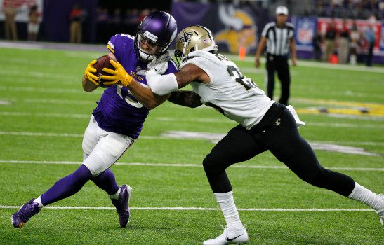 Minnesota Vikings wide receiver Adam Thielen, left, is tackled by New Orleans Saints cornerback P.J. Williams, right, after making a reception during the second half of an NFL football game, Monday, Sept. 11, 2017, in Minneapolis. (AP Photo/Bruce Kluckhohn)
