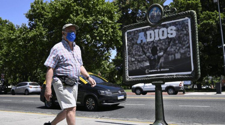 A man walks past a street banner to say goodbye to late Argentine football legend Diego Maradona in Buenos Aires, on November 27, 2020. - Diego Maradona, who died of a heart attack Wednesday at the age of 60, was buried Thursday on the outskirts of Buenos Aires. (Photo by JUAN MABROMATA / AFP) (Photo by JUAN MABROMATA/AFP via Getty Images)