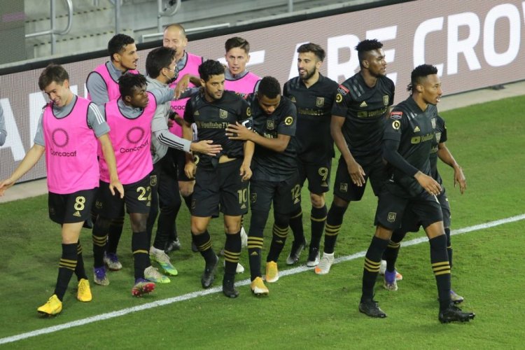 ORLANDO, FL - DECEMBER 19: Carlos Vela #10 of Los Angeles FC celebrates with his teammates after scoring a goal during the CONCACAF Champions League semifinal game against Club America at Exploria Stadium on December 19, 2020 in Orlando, Florida. (Photo by Alex Menendez/Getty Images)