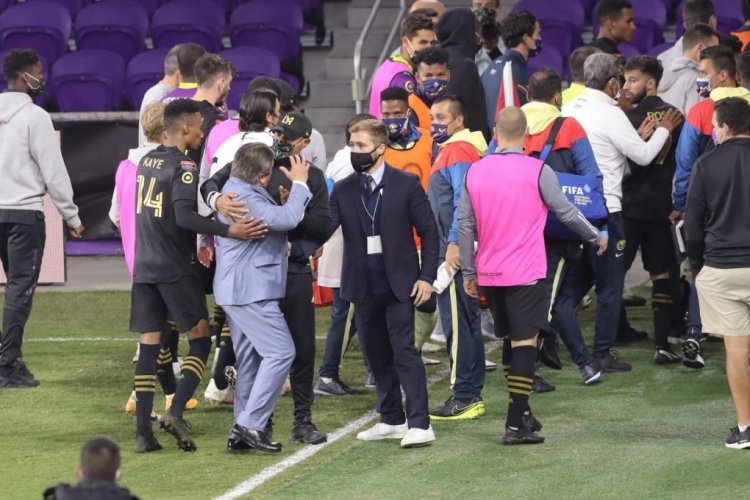 ORLANDO, FL - DECEMBER 19: Head coach Miguel Herrera of Club America is restrained after a halftime scuffle during the CONCACAF Champions League semifinal game against the Los Angeles FC at Exploria Stadium on December 19, 2020 in Orlando, Florida. (Photo by Alex Menendez/Getty Images)
