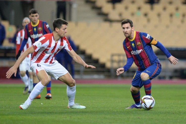 Athletic Bilbao's Spanish midfielder Mikel Vesga (L) vies with Barcelona's Argentinian forward Lionel Messi during the Spanish Super Cup final football match between FC Barcelona and Athletic Club Bilbao at La Cartuja stadium in Seville on January 17, 2021. (Photo by CRISTINA QUICLER / AFP) (Photo by CRISTINA QUICLER/AFP via Getty Images)