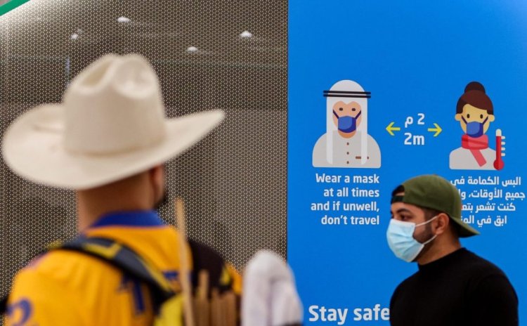 A mask-clad supporter of Mexico's Tigres UANL football club looks at a sign showing safety instructions during the COVID-19 coronavirus pandemicat a station of the Doha Metro while on the way to attend a club fan event outside Education City Stadium in the Qatari city of Ar-Rayyan on January 30, 2021, ahead of their match against Ulsan Hyundai FC the following week. (Photo by KARIM JAAFAR / AFP) (Photo by KARIM JAAFAR/AFP via Getty Images)