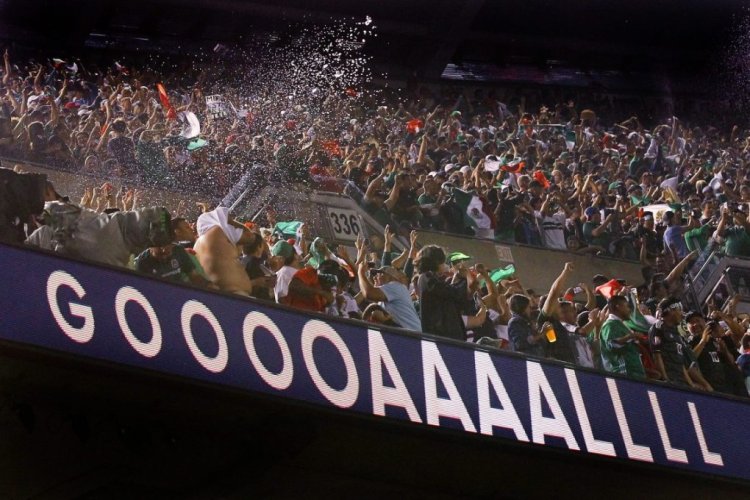 CHICAGO, ILLINOIS - JULY 07:  Mexico fans celebrate after Jonathan dos Santos #6 of the Mexico scored a goal in the second half against the United States during the 2019 CONCACAF Gold Cup Final at Soldier Field on July 07, 2019 in Chicago, Illinois. (Photo by Dylan Buell/Getty Images)