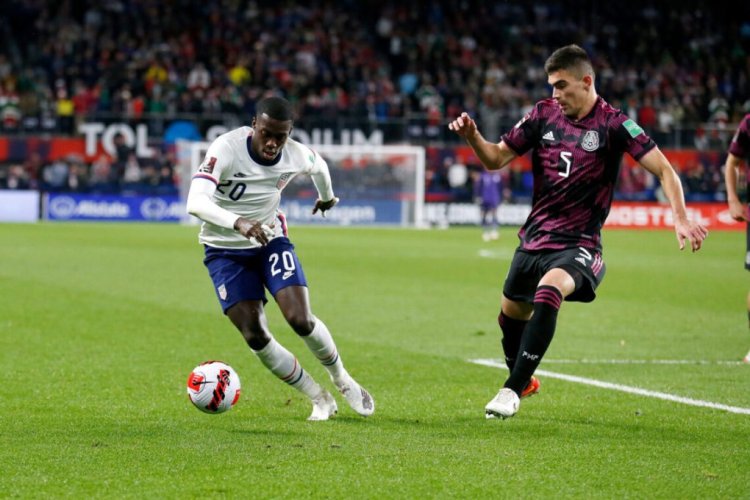 CINCINNATI, OH - NOVEMBER 12:  Tim Weah #20 of the United States attempts to move the ball past Johan Vasquez #5 of Mexico during the first half of the FIFA World Cup 2022 Qualifier match at TQL Stadium on November 12, 2021 in Cincinnati, Ohio. The United States defeated Mexico 2-0.(Photo by Kirk Irwin/Getty Images)