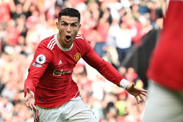 Manchester United's Portuguese striker Cristiano Ronaldo celebrates after scoring his third goal during the English Premier League football match between Manchester United and Norwich City at Old Trafford in Manchester, north west England, on April 16, 2022. - RESTRICTED TO EDITORIAL USE. No use with unauthorized audio, video, data, fixture lists, club/league logos or 'live' services. Online in-match use limited to 120 images. An additional 40 images may be used in extra time. No video emulation. Social media in-match use limited to 120 images. An additional 40 images may be used in extra time. No use in betting publications, games or single club/league/player publications. (Photo by Paul ELLIS / AFP) / RESTRICTED TO EDITORIAL USE. No use with unauthorized audio, video, data, fixture lists, club/league logos or 'live' services. Online in-match use limited to 120 images. An additional 40 images may be used in extra time. No video emulation. Social media in-match use limited to 120 images. An additional 40 images may be used in extra time. No use in betting publications, games or single club/league/player publications. / RESTRICTED TO EDITORIAL USE. No use with unauthorized audio, video, data, fixture lists, club/league logos or 'live' services. Online in-match use limited to 120 images. An additional 40 images may be used in extra time. No video emulation. Social media in-match use limited to 120 images. An additional 40 images may be used in extra time. No use in betting publications, games or single club/league/player publications. (Photo by PAUL ELLIS/AFP via Getty Images)