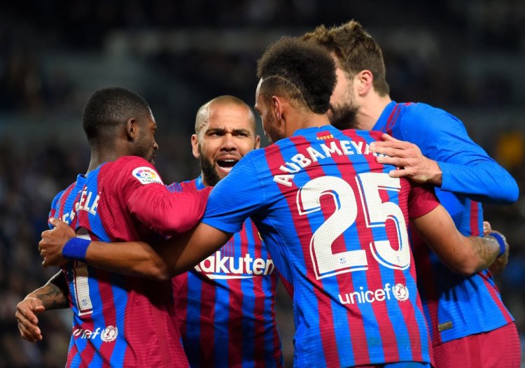 Barcelona's Gabonese midfielder Pierre-Emerick Aubameyang celebrates with teammates after scoring the opening goal during the Spanish League football match between Real Sociedad and FC Barcelona at the Anoeta stadium in San Sebastian on April 21, 2022. (Photo by ANDER GILLENEA / AFP) (Photo by ANDER GILLENEA/AFP via Getty Images)