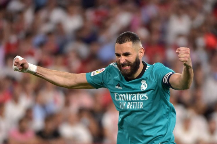 Real Madrid's French forward Karim Benzema celebrates after Real Madrid's Spanish defender Nacho Fernandez scored a goal during the Spanish League football match between Sevilla FC and Real Madrid CF at the Ramon Sanchez Pizjuan stadium in Seville on April 17, 2022. (Photo by CRISTINA QUICLER / AFP) (Photo by CRISTINA QUICLER/AFP via Getty Images)