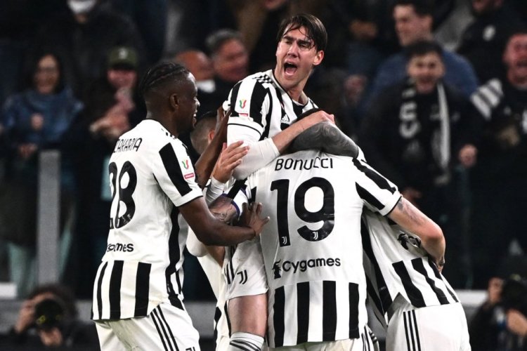 Juventus' Serbian forward Dusan Vlahovic (C) and Juventus' Swiss midfielder Denis Zakaria (L) celebrate after Juventus opened the scoring during the Italian Cup (Coppa Italia) semifinal, second leg football match between Juventus and Fiorentina on April 20, 2022 at the Juventus stadium in Turin. (Photo by Marco BERTORELLO / AFP) (Photo by MARCO BERTORELLO/AFP via Getty Images)