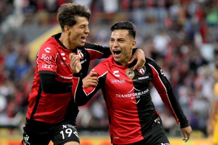 Atlas' Ian Torres celebrates (R) after scoring against Tigres during the Mexican Clausura tournament football match at the Jalisco stadium in Guadalajara, Jalisco State, Mexico, on April 30, 2022. (Photo by Ulises Ruiz / AFP) (Photo by ULISES RUIZ/AFP via Getty Images)