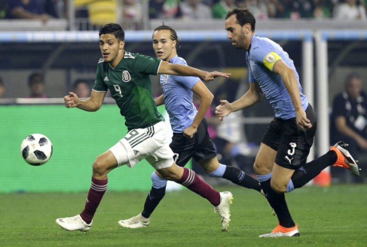 HOUSTON, TX - SEPTEMBER 07:  Raul Jimenez #9 of Mexico brings the ball up the field as Diego Godin #3 of Uruguay pursues in the first half during the International Friendly match between Mexico and Uruguay at NRG Stadium on September 7, 2018 in Houston, United States.  (Photo by Bob Levey/Getty Images)
