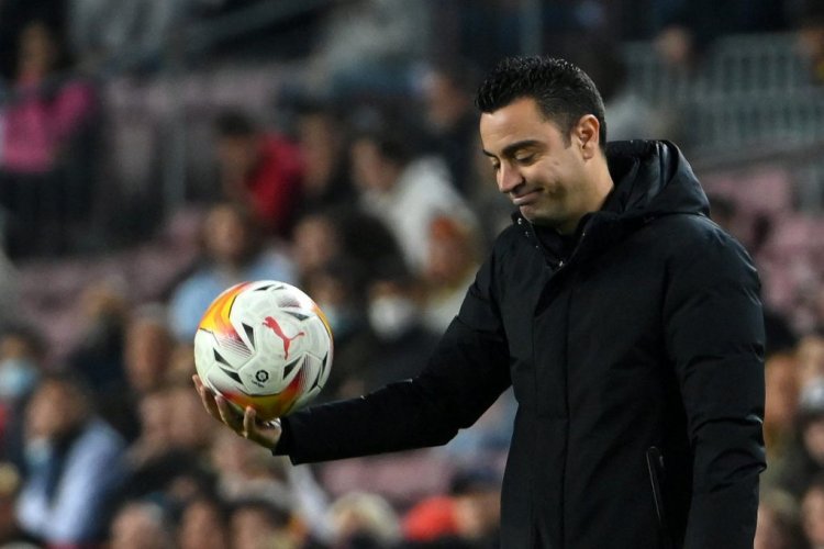 TOPSHOT - Barcelona's Spanish coach Xavi holds a ball during the Spanish League football match between FC Barcelona and Cadiz CF at the Camp Nou stadium in Barcelona on April 18, 2022. (Photo by LLUIS GENE / AFP) (Photo by LLUIS GENE/AFP via Getty Images)