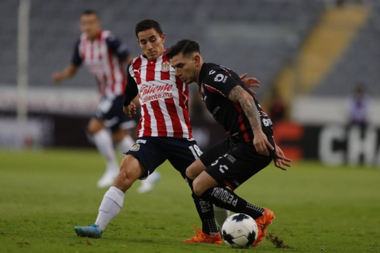 GUADALAJARA, MEXICO - MARCH 20: Jose Abella of Atlas fights for the ball with Sebastian Perez of Chivas during the 11th round match between Atlas and Chivas as part of the Torneo Grita Mexico C22 Liga MX at Jalisco Stadium on March 20, 2022 in Guadalajara, Mexico. (Photo by Refugio Ruiz/Getty Images)
