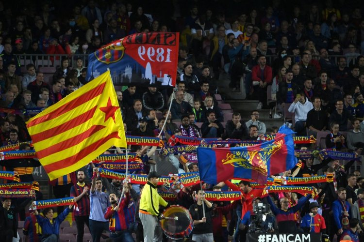 Barcelona supporters cheer from the stands during the Spanish league football match between FC Barcelona and Rayo Vallecano de Madrid at the Camp Nou stadium in Barcelona on April 24, 2022. (Photo by LLUIS GENE / AFP) (Photo by LLUIS GENE/AFP via Getty Images)