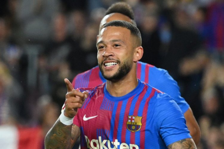 Barcelona's Dutch forward Memphis Depay celebrates after scoring a goal during the Spanish league football match between FC Barcelona and RC Celta de Vigo at the Camp Nou stadium in Barcelona on May 10, 2022. (Photo by LLUIS GENE / AFP) (Photo by LLUIS GENE/AFP via Getty Images)