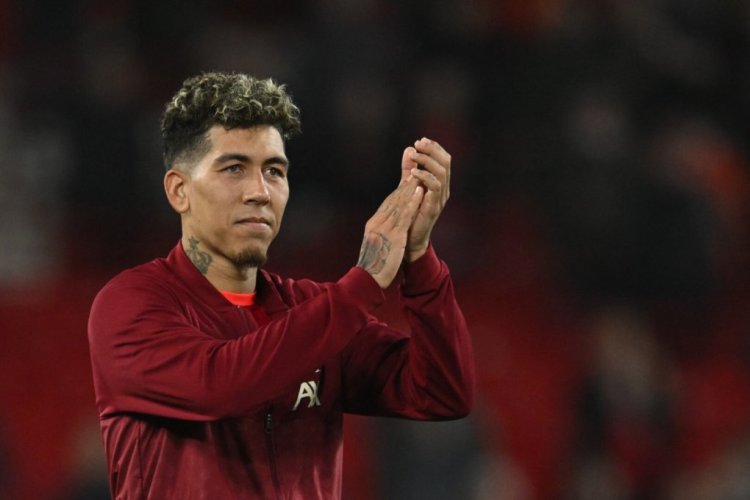 Liverpool's Brazilian midfielder Roberto Firmino applauds at the end of the UEFA Champions League quarter final second leg football match between Liverpool and Benfica at the Anfield stadium, in Liverpool, on April 13, 2022. - Liverpool and Benfica scored three goals each but Liverpool is qualified for the semi-finals. (Photo by Paul ELLIS / AFP) (Photo by PAUL ELLIS/AFP via Getty Images)