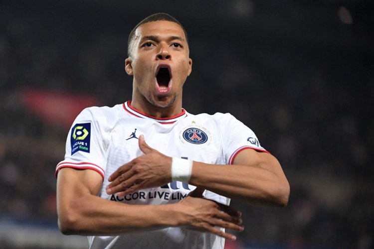 Paris Saint-Germain's French forward Kylian Mbappe celebrates scoring his team's third goal during the French L1 football match between Strasbourg RC and Paris Saint-Germain (PSG) at La Meinau stadium in Strasbourg, eastern France, on April 29, 2022. (Photo by Patrick HERTZOG / AFP) (Photo by PATRICK HERTZOG/AFP via Getty Images)
