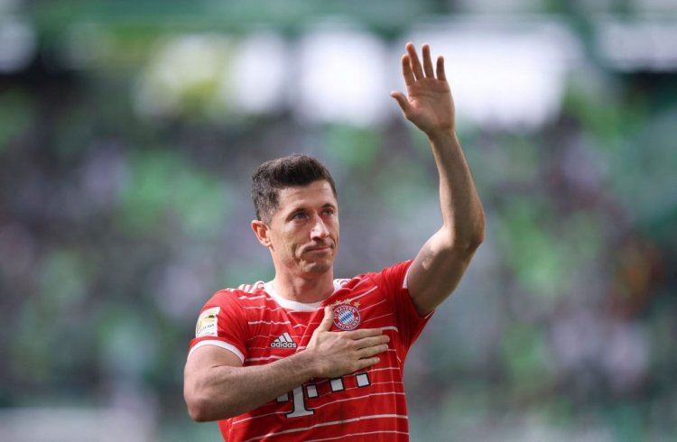 Bayern Munich's Polish forward Robert Lewandowski greets and holds a hand on his heart after the German first division Bundesliga football match VfL Wolfsburg v Bayern Munich in Wolfsburg, northern Germany, on May 14, 2022. - DFL REGULATIONS PROHIBIT ANY USE OF PHOTOGRAPHS AS IMAGE SEQUENCES AND/OR QUASI-VIDEO (Photo by Ronny Hartmann / AFP) / DFL REGULATIONS PROHIBIT ANY USE OF PHOTOGRAPHS AS IMAGE SEQUENCES AND/OR QUASI-VIDEO (Photo by RONNY HARTMANN/AFP via Getty Images)
