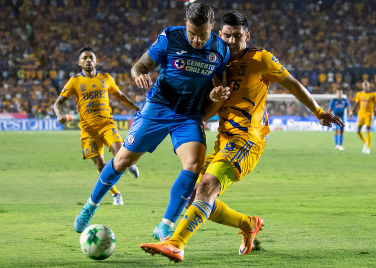 Jesus Angulo (R) of Tigres vies for the ball with Alexis Pena (L) of Cruz Azul during a Mexican Clausura tournament football match between Cruz Azul and Tigres at Universitario stadium in Monterrey, Mexico, on May 15, 2022. (Photo by Julio Cesar AGUILAR / AFP) (Photo by JULIO CESAR AGUILAR/AFP via Getty Images)