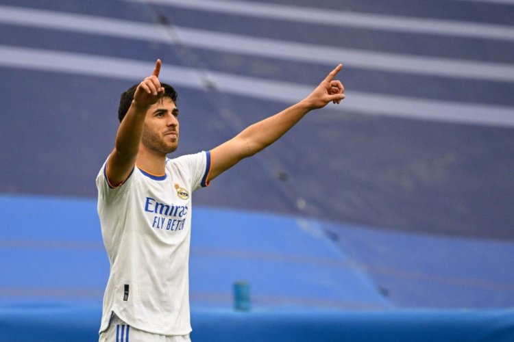 Real Madrid's Spanish midfielder Marco Asensio celebrates after scoring his team's third goal during the Spanish League football match between Real Madrid CF and RCD Espanyol at the Santiago Bernabeu stadium in Madrid on April 30, 2022. (Photo by GABRIEL BOUYS / AFP) (Photo by GABRIEL BOUYS/AFP via Getty Images)