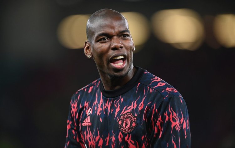 MANCHESTER, ENGLAND - MARCH 15: Paul Pogba of Manchester United warms up prior to the UEFA Champions League Round Of Sixteen Leg Two match between Manchester United and Atletico Madrid at Old Trafford on March 15, 2022 in Manchester, England. (Photo by Michael Regan/Getty Images)