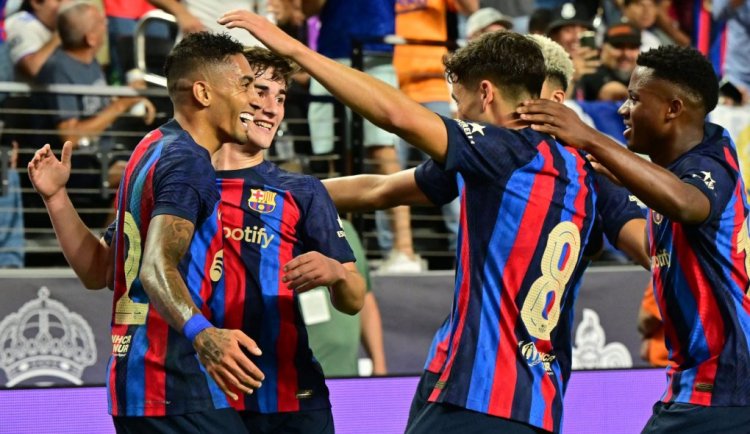 Barcelona's Raphinha celebrates with teammates after scoring during the international friendly football match between Barcelona and Real Madrid at Allegiant Stadium in Las Vegas, Nevada, on July 23, 2022. (Photo by Frederic J. BROWN / AFP) (Photo by FREDERIC J. BROWN/AFP via Getty Images)