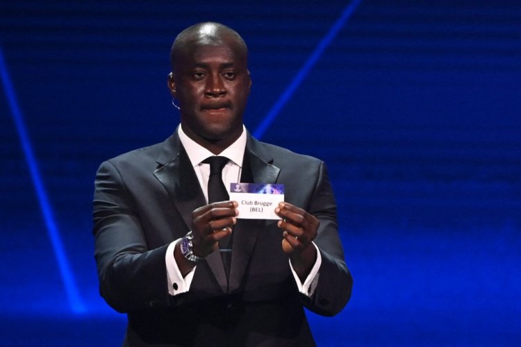 Former Ivorian midfielder Yaya Toure shows the paper slip of Belgium's Club Brugge during the draw for the UEFA Champions League football tournament 2022-2023 in Istanbul on August 25, 2022. (Photo by OZAN KOSE / AFP) (Photo by OZAN KOSE/AFP via Getty Images)