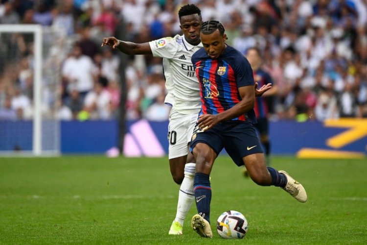 Real Madrid's Brazilian forward Vinicius Junior (L) fights for the ball with Barcelona's French defender Jules Kounde during the Spanish League football match between Real Madrid CF and FC Barcelona at the Santiago Bernabeu stadium on October 16, 2022. (Photo by PIERRE-PHILIPPE MARCOU / AFP) (Photo by PIERRE-PHILIPPE MARCOU/AFP via Getty Images)