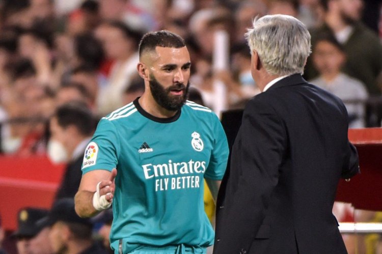 Real Madrid's French forward Karim Benzema (L) celebrates with Real Madrid's Italian coach Carlo Ancelotti at the end of the Spanish League football match between Sevilla FC and Real Madrid CF at the Ramon Sanchez Pizjuan stadium in Seville on April 17, 2022. (Photo by CRISTINA QUICLER / AFP) (Photo by CRISTINA QUICLER/AFP via Getty Images)
