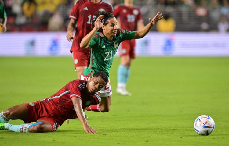 Mexico's forward Diego Lainez (R) falls next to Colombia's midfielder Wilmar Barrios during the international friendly football match between Mexico and Colombia at Levi's Stadium in Santa Clara, California, on September 27, 2022. (Photo by Frederic J. BROWN / AFP) (Photo by FREDERIC J. BROWN/AFP via Getty Images)