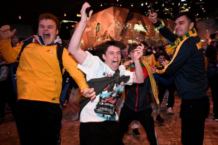 Australian fans celebrate in Melbourne on December 1, 2022, after Australia's victory over Denmark in their Qatar 2022 World Cup Group D football match. (Photo by William WEST / AFP) (Photo by WILLIAM WEST/AFP via Getty Images)