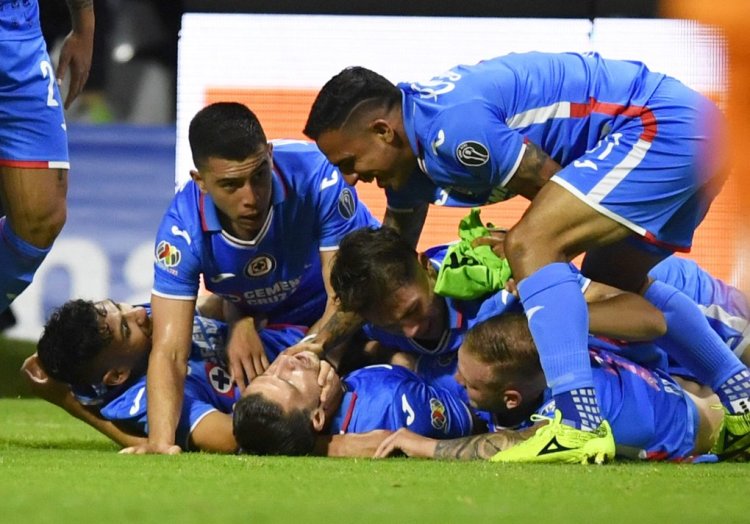 Jose Rivero (down, C) of Cruz Azul celebrates with teammates after scoring goal against Leon during their Mexican Apertura 2022 tournament playoff football match at Azteca Stadium in Mexico City, on October 8, 2022. (Photo by CLAUDIO CRUZ / AFP) (Photo by CLAUDIO CRUZ/AFP via Getty Images)