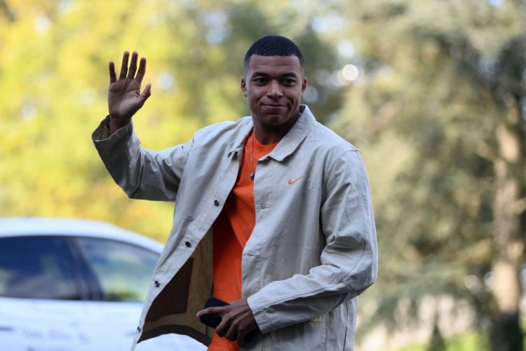 France's forward Kylian Mbappe gestures as he arrives for a get-together, two days before the French national team leave for the upcoming Qatar 2022 World Cup football tournament, at the team's training ground in Clairefontaine-en-Yvelines, outside Paris on November 14, 2022. - The week-long countdown to the World Cup in Qatar begins as the world's leading footballers focused their attention on one of the most controversial tournaments in history. The first World Cup to be held in the Arab world will kick off on November 20, 2022, when the host nation face Ecuador. (Photo by FRANCK FIFE / AFP) (Photo by FRANCK FIFE/AFP via Getty Images)