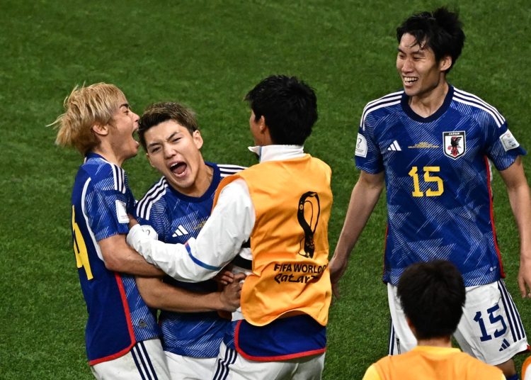 Japan's midfielder #08 Ritsu Doan (2nd-L) celebrates with teammates after scoring the first goal in the Qatar 2022 World Cup Group E football match between Germany and Japan at the Khalifa International Stadium in Doha on November 23, 2022. (Photo by Anne-Christine POUJOULAT / AFP) (Photo by ANNE-CHRISTINE POUJOULAT/AFP via Getty Images)
