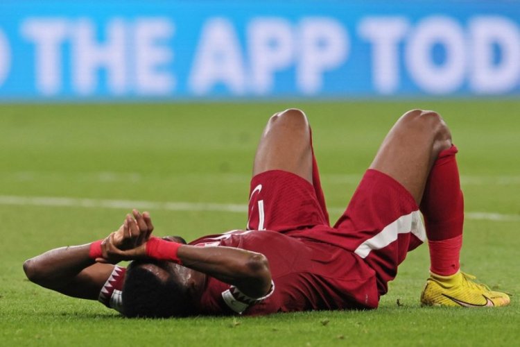 Qatar's defender #17 Ismaiel Mohammed reacts to their defeat on the pitch after the Qatar 2022 World Cup Group A football match between Qatar and Senegal at the Al-Thumama Stadium in Doha on November 25, 2022. (Photo by KARIM JAAFAR / AFP) (Photo by KARIM JAAFAR/AFP via Getty Images)