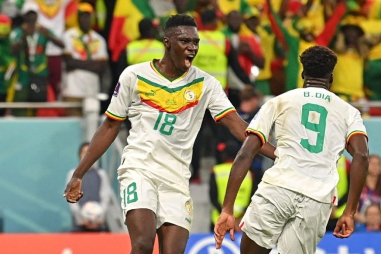 Senegal's forward #09 Boulaye Dia (R) celebrates scoring his team's first goal with Senegal's forward #18 Ismaila Sarr (L) during the Qatar 2022 World Cup Group A football match between Qatar and Senegal at the Al-Thumama Stadium in Doha on November 25, 2022. (Photo by Glyn KIRK / AFP) (Photo by GLYN KIRK/AFP via Getty Images)