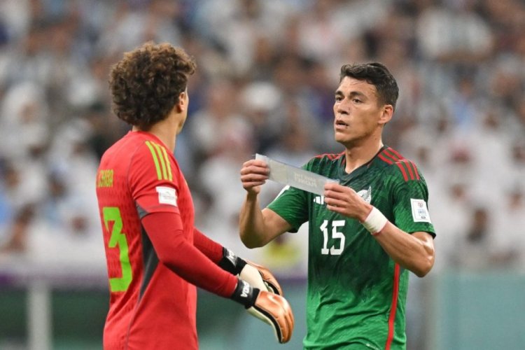 Mexico's goalkeeper #13 Guillermo Ochoa (L) is given the captain's armband by Mexico's defender #15 Hector Moreno (R) during the Qatar 2022 World Cup Group C football match between Argentina and Mexico at the Lusail Stadium in Lusail, north of Doha on November 26, 2022. (Photo by Glyn KIRK / AFP) (Photo by GLYN KIRK/AFP via Getty Images)