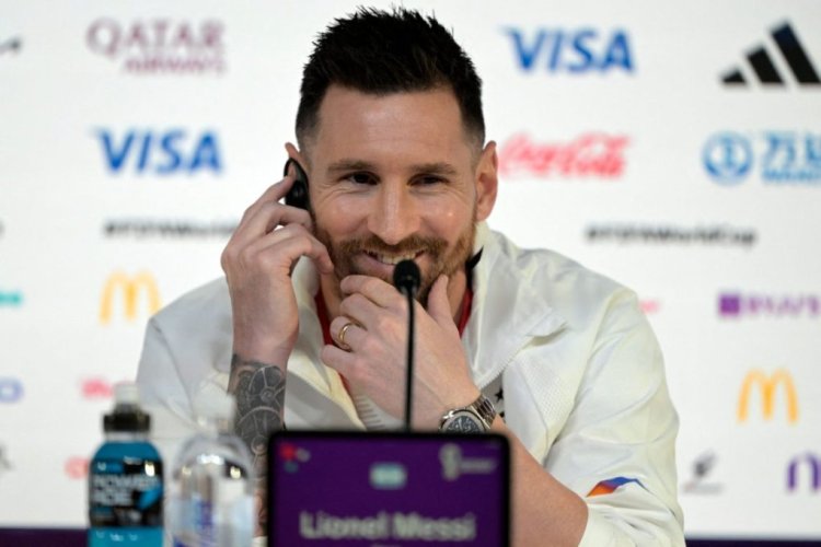Argentina's forward Lionel Messi smiles as he gives a press conference at the Qatar National Convention Centre (QNCC) in Doha, on November 21, 2022, on the eve of the Qatar 2022 World Cup football match between Argentina and Saudi Arabia. (Photo by JUAN MABROMATA / AFP) (Photo by JUAN MABROMATA/AFP via Getty Images)