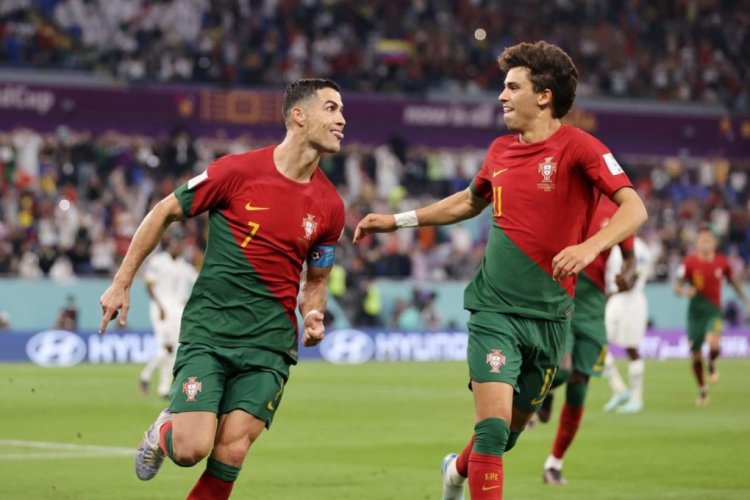 DOHA, QATAR - NOVEMBER 24: Cristiano Ronaldo of Portugal celebrates with Joao Felix after scoring their team's first goal via a penalty during the FIFA World Cup Qatar 2022 Group H match between Portugal and Ghana at Stadium 974 on November 24, 2022 in Doha, Qatar. (Photo by Clive Brunskill/Getty Images)