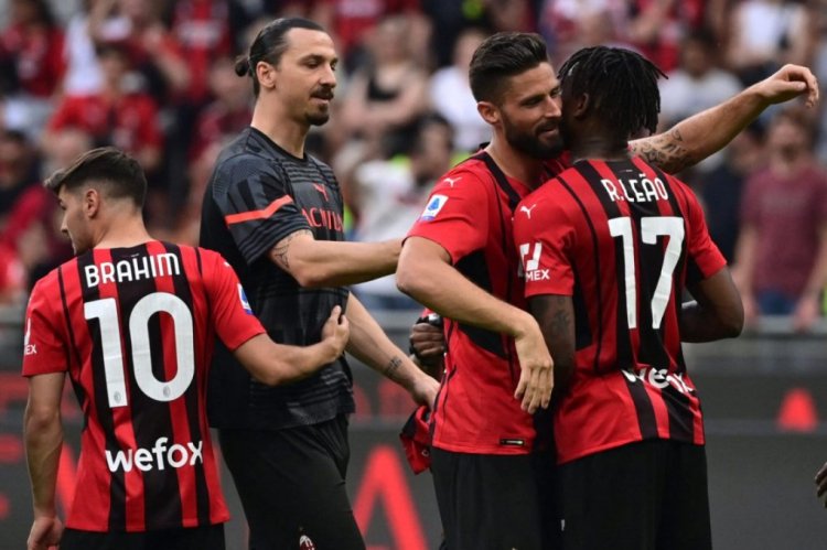 AC Milan's French defender Theo Hernandez who scored the second goal of the match congratulates AC Milan's Portuguese forward Rafael Leao who scored the first goal of the match as AC Milan's Swedish forward Zlatan Ibrahimovic (2ns L) looks on at the end of the match after the team won 2-0 against Atalanta during the Italian Serie A football match between AC Milan and Atalanta Bergamo at the San Siro stadium in Milan on May 15, 2022. (Photo by MIGUEL MEDINA / AFP) (Photo by MIGUEL MEDINA/AFP via Getty Images)
