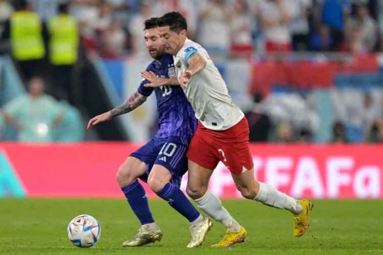 Argentina's forward #10 Lionel Messi (L) and Poland's forward #09 Robert Lewandowski fight for the ball during the Qatar 2022 World Cup Group C football match between Poland and Argentina at Stadium 974 in Doha on November 30, 2022. (Photo by JUAN MABROMATA / AFP) (Photo by JUAN MABROMATA/AFP via Getty Images)