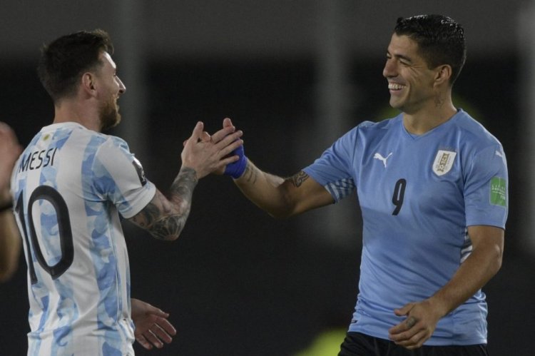 Argentina's Lionel Messi (L) greets Uruguay's Luis Suarez before the start of the South American qualification football match for the FIFA World Cup Qatar 2022, at the Monumental stadium in Buenos Aires, on October 10, 2021. (Photo by Juan Mabromata / AFP) (Photo by JUAN MABROMATA/AFP via Getty Images)