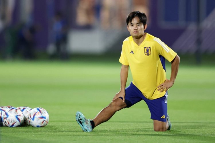 DOHA, QATAR - NOVEMBER 30: Takefusa Kubo of Japan stretches  during the Japan Training Session at Al Sadd SC New Training Facilities on November 30, 2022 in Doha, Qatar. (Photo by Mohamed Farag/Getty Images)