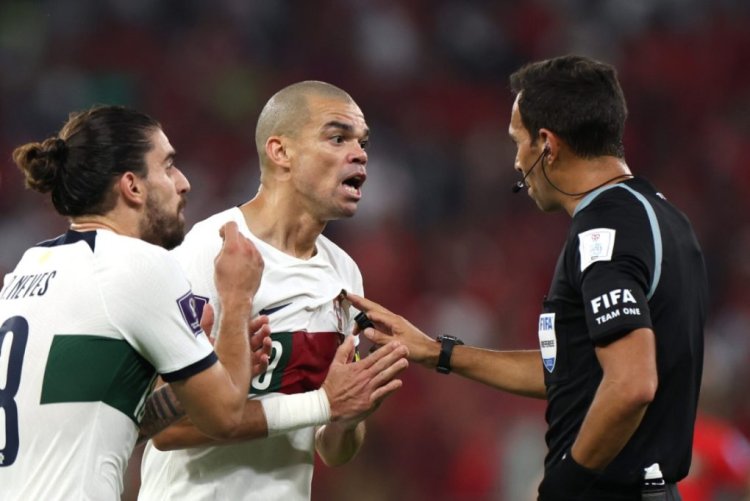 DOHA, QATAR - DECEMBER 10: Referee Facundo Tello speaks to Pepe of Portugal after an incident during the FIFA World Cup Qatar 2022 quarter final match between Morocco and Portugal at Al Thumama Stadium on December 10, 2022 in Doha, Qatar. (Photo by Francois Nel/Getty Images)