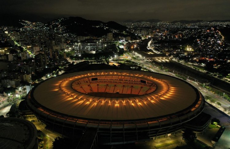 TOPSHOT - Maracana stadium is illuminated with a golden light in honour of Brazilian football legend Pele, in Rio de Janeiro, Brazil on December 29, 2022, on the day of his passing at a Sao Paulo hospital. - Brazilian football icon Pele, widely regarded as the greatest player of all time and a three-time World Cup winner who masterminded the "beautiful game," died on Thursday at the age of 82. The Albert Einstein hospital treating Pele said in a statement his death after a long battle with cancer was caused by "multiple organ failure." (Photo by Mauro PIMENTEL / AFP) (Photo by MAURO PIMENTEL/AFP via Getty Images)