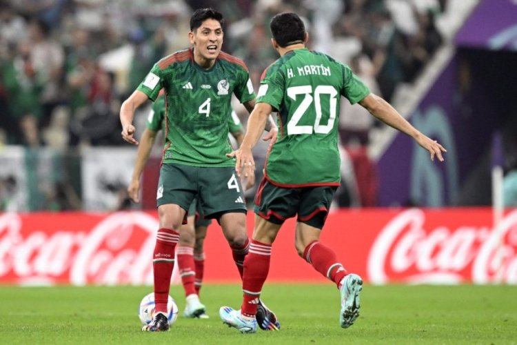 TOPSHOT - Mexico's forward #20 Henry Martin (R) celebrates scoring his team's first goal during the Qatar 2022 World Cup Group C football match between Saudi Arabia and Mexico at the Lusail Stadium in Lusail, north of Doha on November 30, 2022. (Photo by Alfredo ESTRELLA / AFP) (Photo by ALFREDO ESTRELLA/AFP via Getty Images)