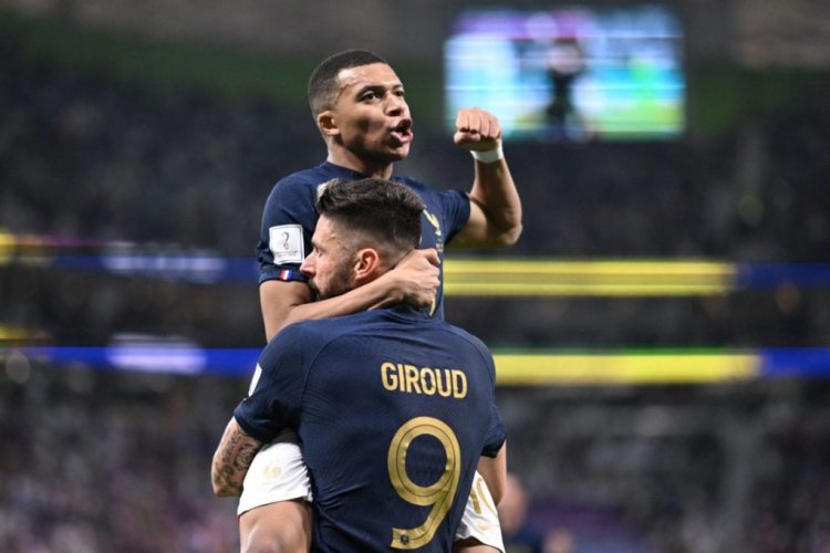 TOPSHOT - France's forward #09 Olivier Giroud celebrates with France's forward #10 Kylian Mbappe (top) after scoring his team's first goal during the Qatar 2022 World Cup round of 16 football match between France and Poland at the Al-Thumama Stadium in Doha on December 4, 2022. (Photo by Kirill KUDRYAVTSEV / AFP) (Photo by KIRILL KUDRYAVTSEV/AFP via Getty Images)