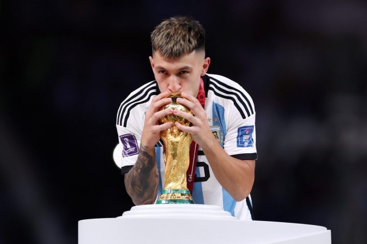 LUSAIL CITY, QATAR - DECEMBER 18: Lisandro Martinez of Argentina kisses the FIFA World Cup winning trophy during the award ceremony following the FIFA World Cup Qatar 2022 Final match between Argentina and France at Lusail Stadium on December 18, 2022 in Lusail City, Qatar. (Photo by Clive Brunskill/Getty Images)